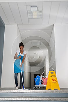 Woman Mopping Corridor