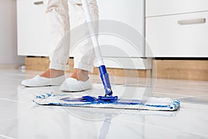 Woman Mopping The Floor In Kitchen