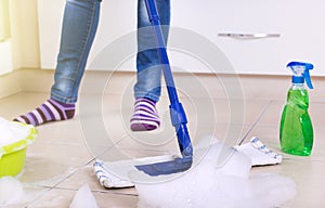 Woman mopping kitchen floor