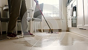 Woman Mopping Kitchen Tiled Floor