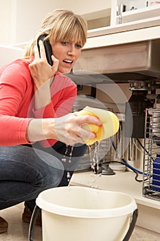 Woman Mopping Up Leaking Sink