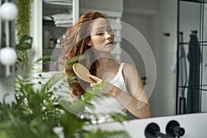 Woman during the morning rutine at the bathroom