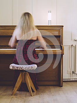 Woman with motion blur playing the piano