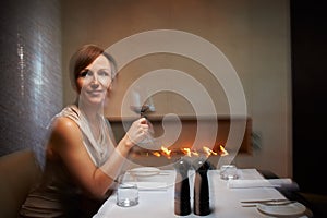 Woman, motion blur and restaurant for dinner, table or wine glass for celebration. Alcohol, intoxicated and drunk for photo