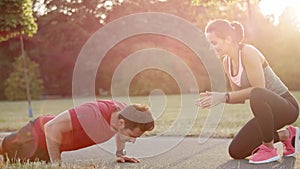 Woman motivating his boyfriend to workout