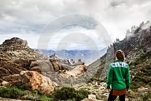 Woman on mountain admiring majestic landscape in Arizona, USA