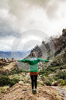 Woman on mountain admiring majestic landscape in Arizona, USA