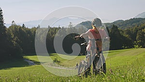 Woman with mountain bike in nature
