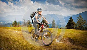 Woman mountain-bike riding photo