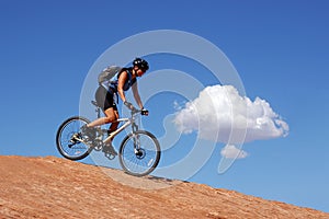 Woman mountain biking photo