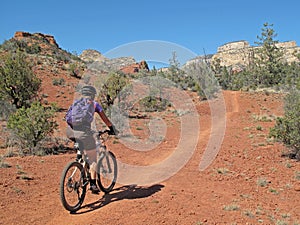 Woman mountain biking in the red rocks, Sedona, USA