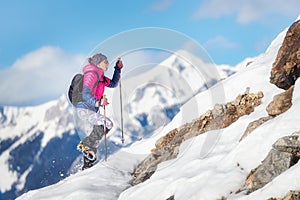 Woman mountaineer during a descent with crampons on snowy slope