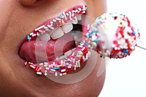 Woman mouth with colored candy