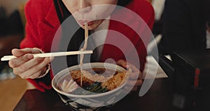 Woman, mouth and eating ramen in restaurant for dinner, meal and noodles in cafeteria. Closeup, hungry lady and