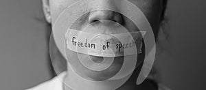 Woman with mouth sealed in adhesive tape with Freedom  of Speech message., freedom of press, Human rights, Protest dictatorship,