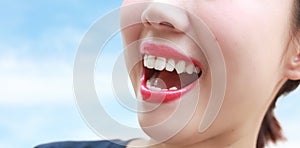 Woman mouth smile with great teeth over blue background.