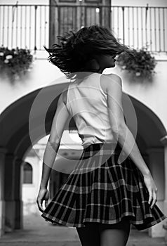 Woman movement in skirt, fashion style. Beautiful sexy girl with casual dress walking on the street.