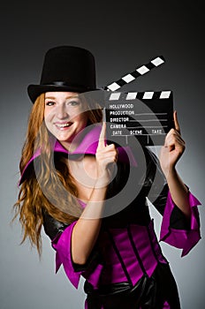 Woman with movie clapboard against