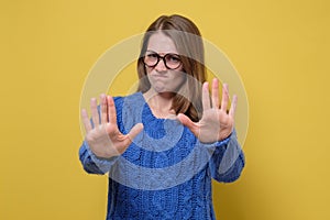 Woman moving away hands palms showing refusal and denial gesture