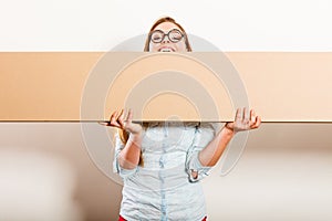 Woman moving in carrying box. Blank copyspace.