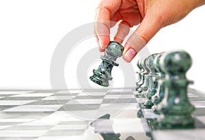 Woman moving a chess piece ahead