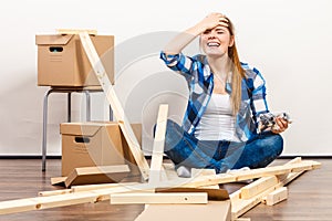 Woman moving in holding screws and furniture parts