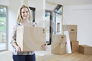 Woman Moving Into New Home With Packing Box