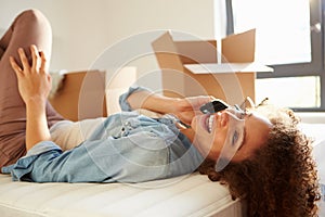 Woman Moving Into New Home Talking On Mobile Phone