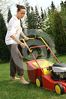 Woman mowing grass