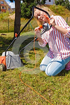 Woman mowing green grass