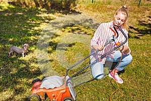 Woman mowing green grass