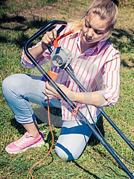 Woman mowing green grass