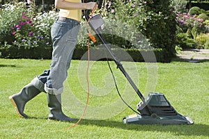 Woman Mowing Lawn