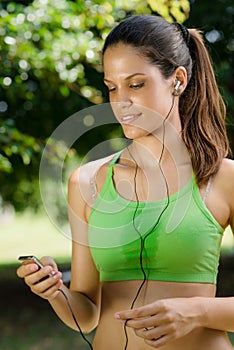 Woman with mp3 player listening to music