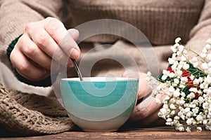 Woman with a mug of tea in her hands