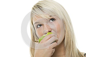 Woman munching on a green apple