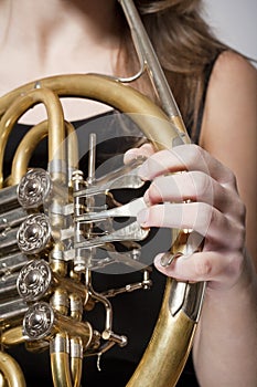 Woman musician with french horn