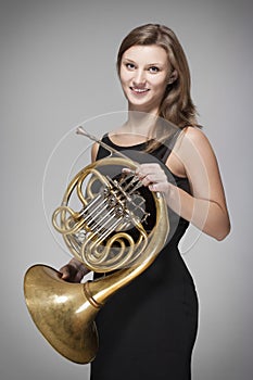 Woman musician with french horn