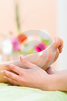 Woman in nail salon receiving foot massage