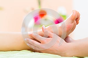 Woman in nail salon receiving foot massage photo