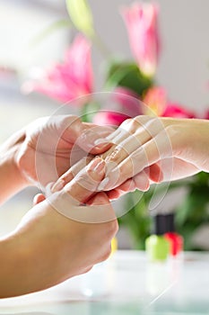 Woman in nail salon receiving hand massage