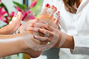 Woman in nail studio receiving pedicure