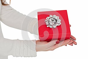 Woman with nail varnish holding red gift