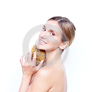 Woman with naked back keeps natural sponge and smiling with teeth . SPA and beauty.