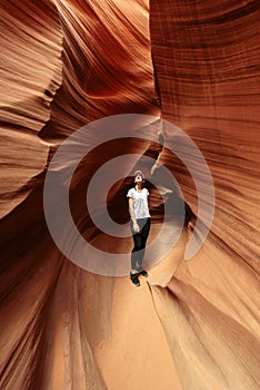 Woman in narrow cave of Antelope Canyon