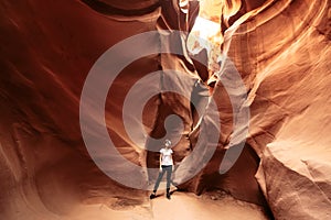 Woman in narrow cave of Antelope Canyon