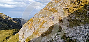 Woman on narrow mountain trail