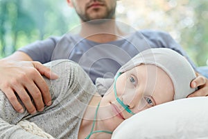 Woman with nasal cannula lying photo