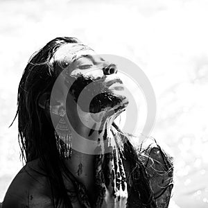 Woman with natural mud mask. Woman relaxing with a charcoal facial mask. Portrait of a beauty girl with spa mud mask on