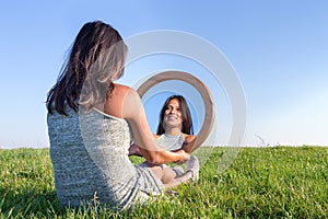 Woman in nature viewing her mirror image